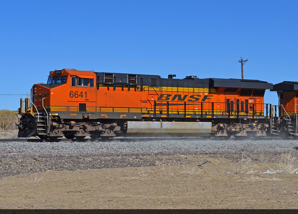 BNSF 6641 kicks up dust from freshly laid ballast